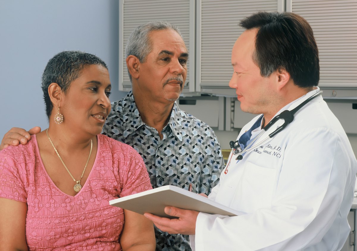 A doctor reviewing information with an older couple